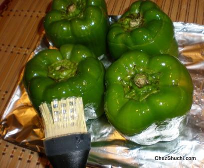 brushing oil on stuffed bell pepper